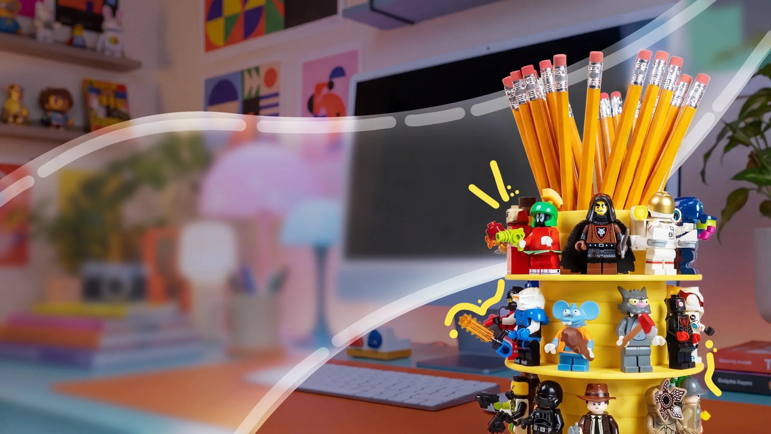 Desk with stationery items including pencils and LEGO minifigures in a colorful room.